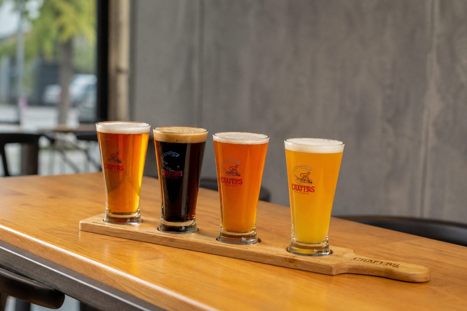 Beer flight lined up on a tasting paddle