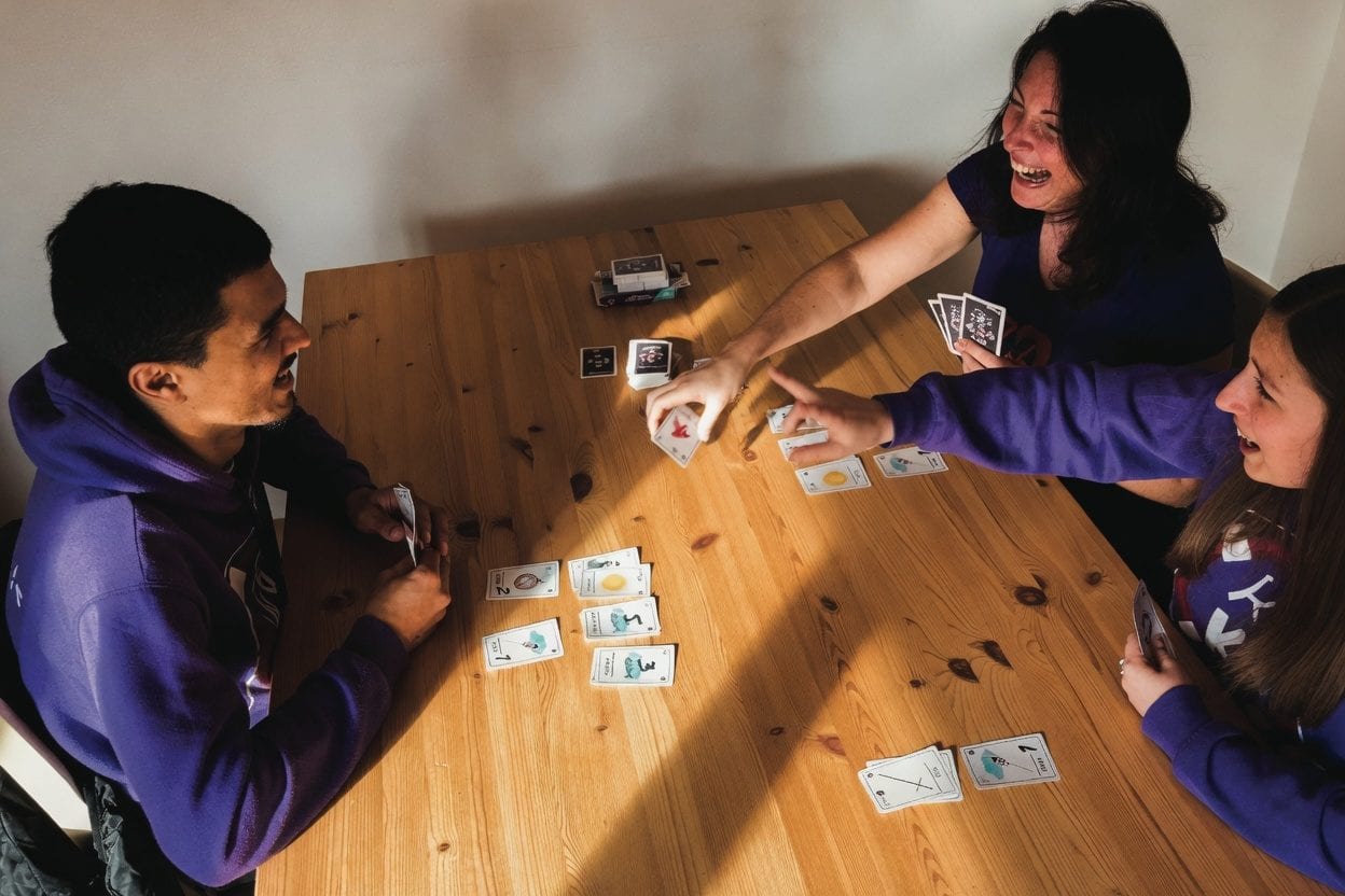 A group gathered around a wooden table