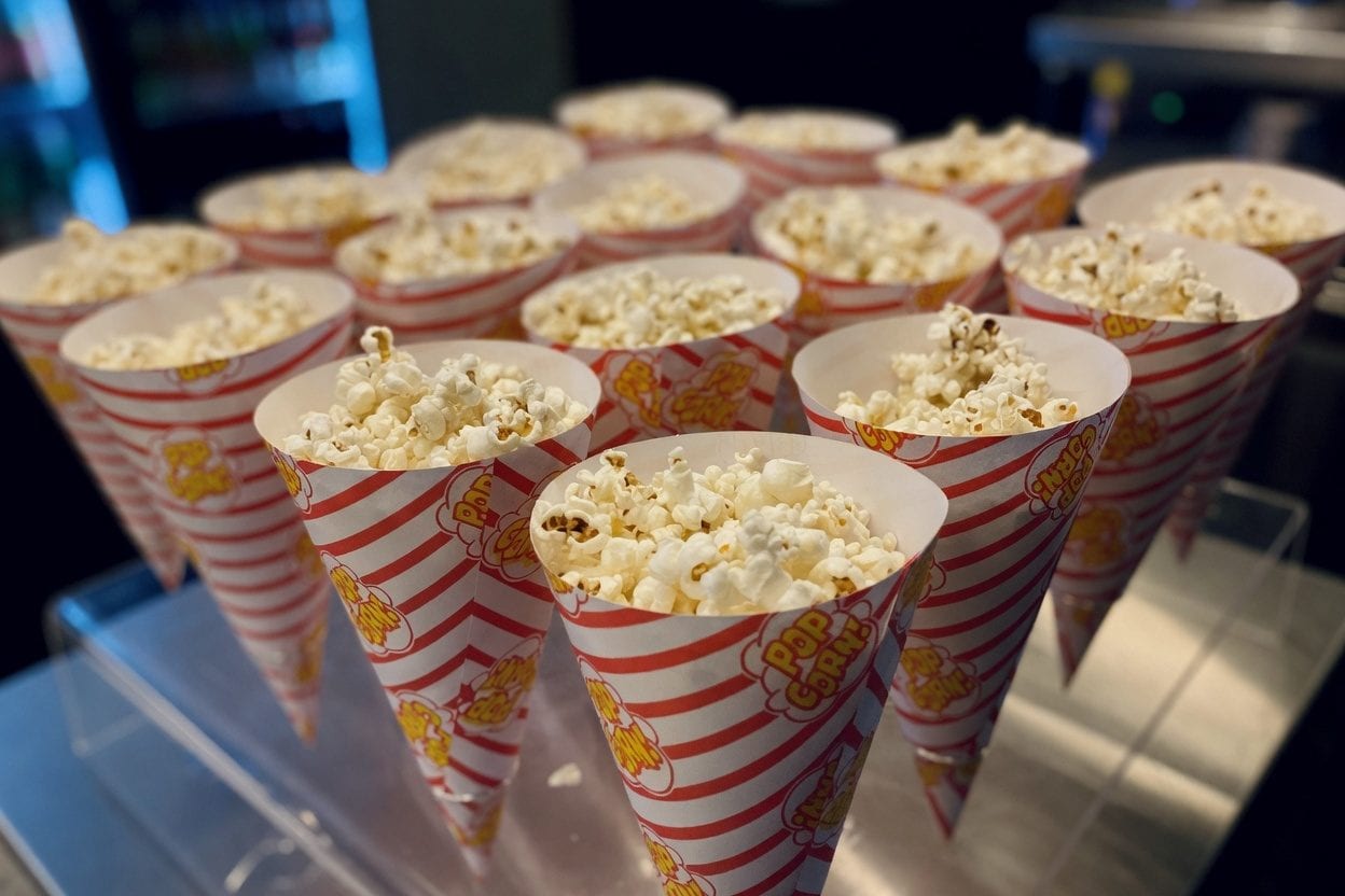 Popcorn machine and party tables beside an inflatable