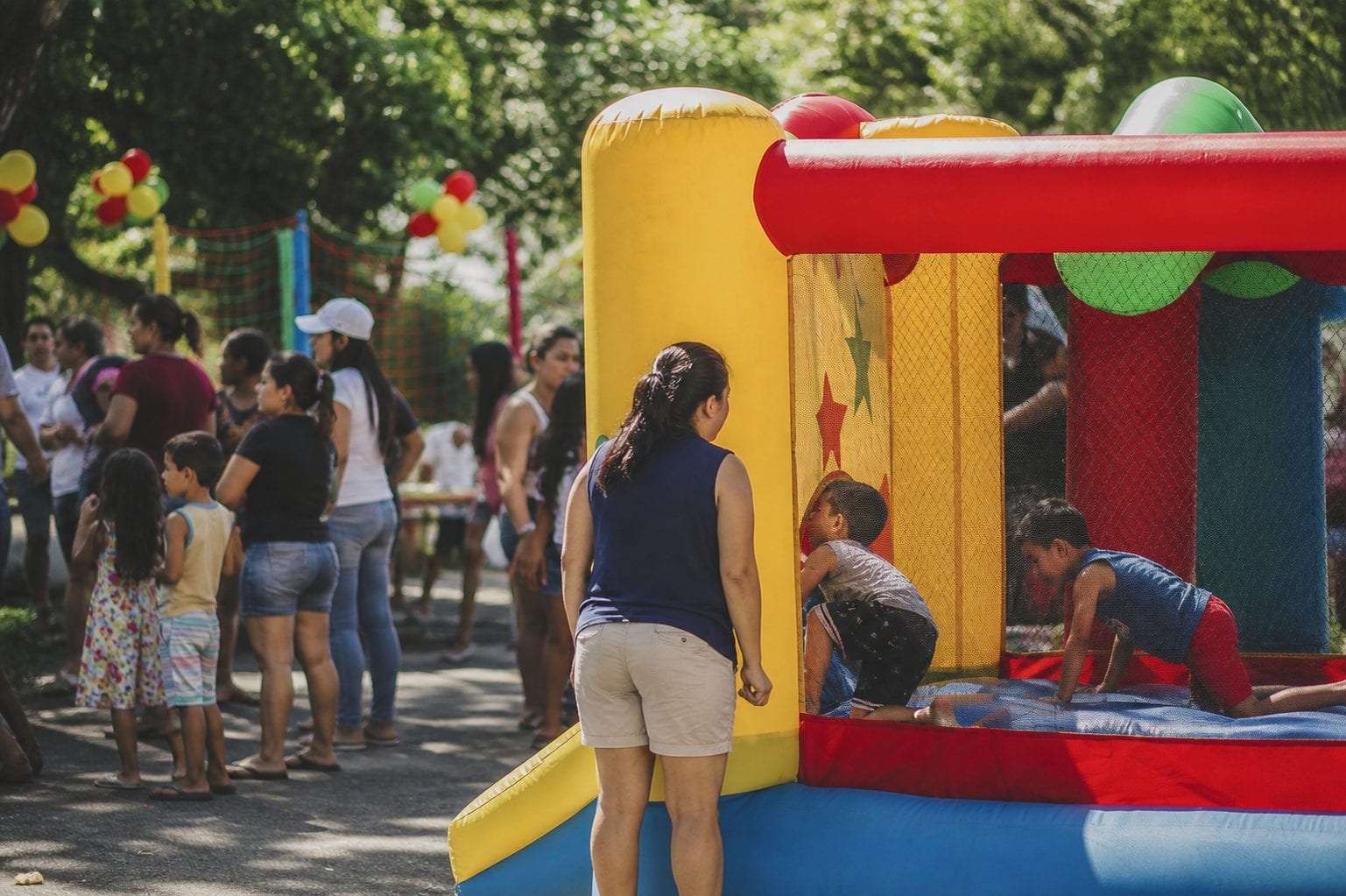Adult supervising kids in an inflatable
