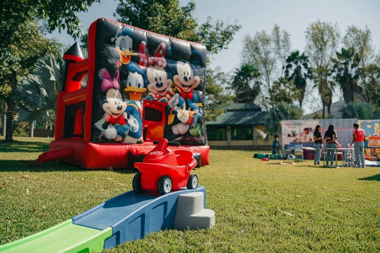 Colourful bounce house with a slide in a backyard