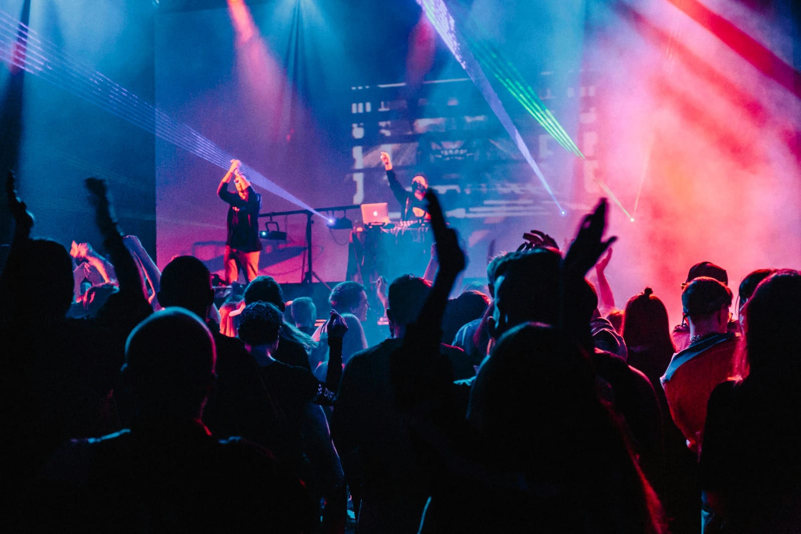 Live concert performance with band on stage and crowd.