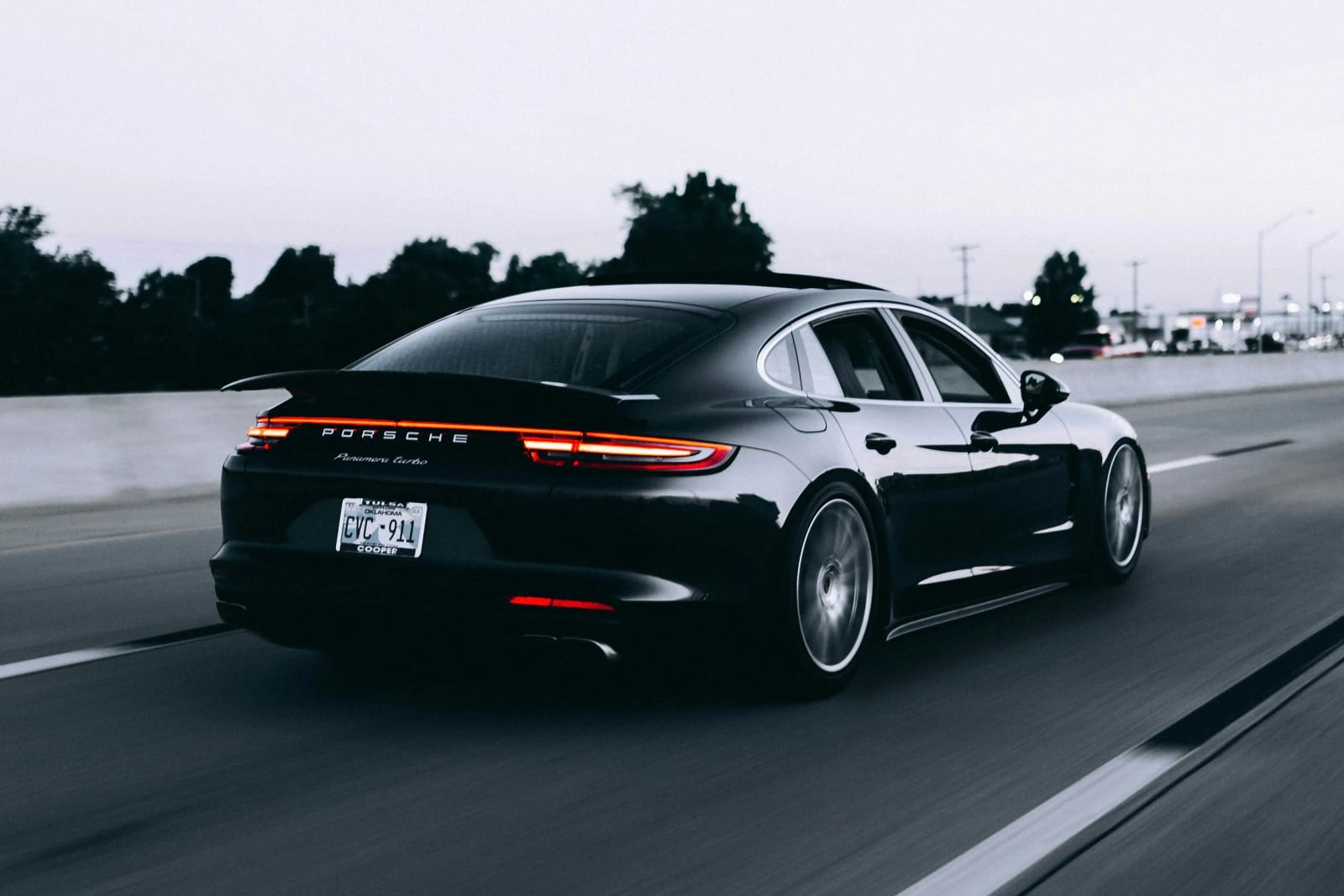 Car speedometer showing high speed on highway.