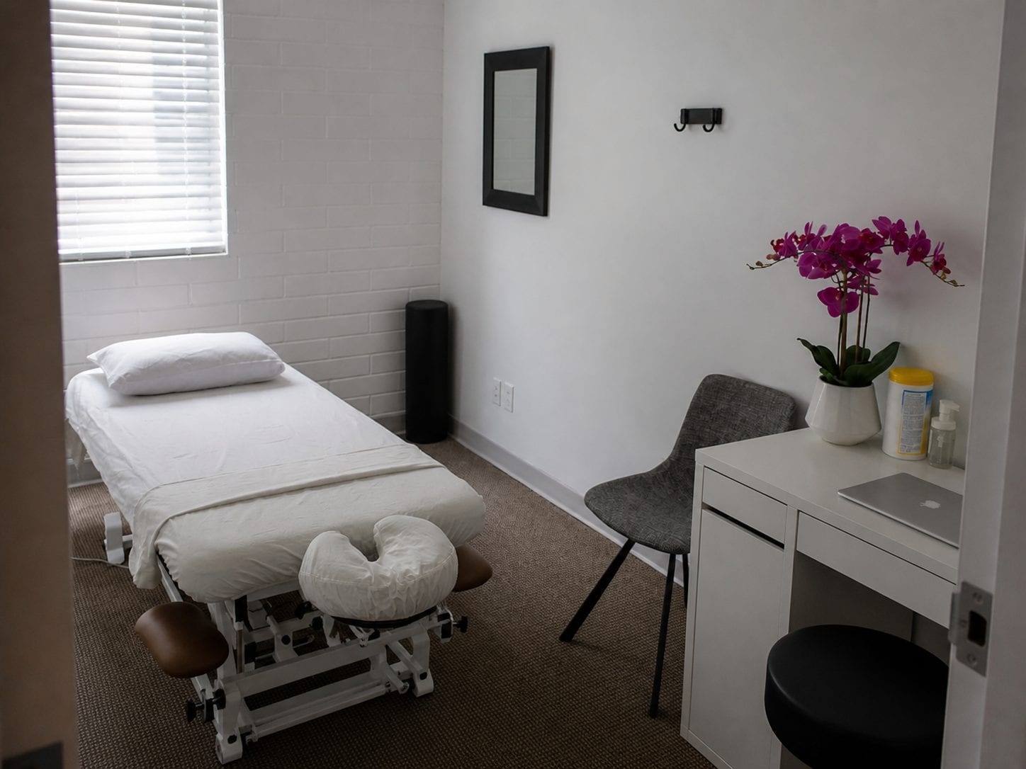 Massage therapist preparing a treatment room