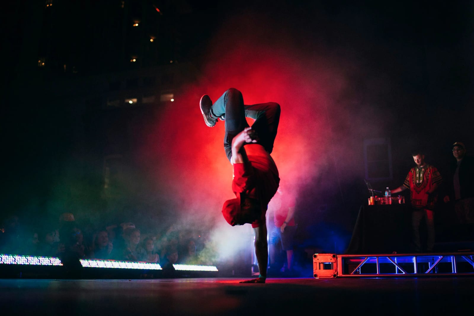 Dancers performing on stage with colorful lights