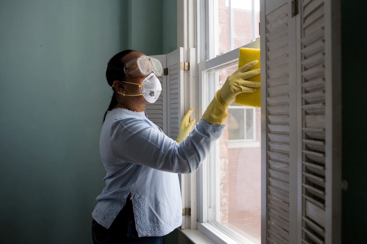 Contractor at front door with clipboard