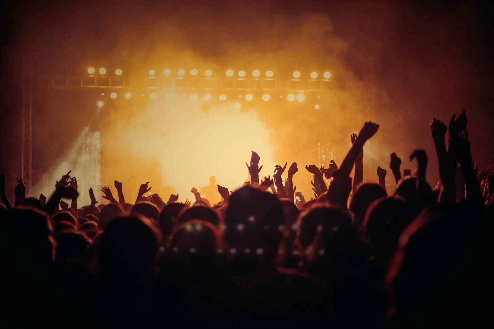 Festivalgoers enjoying live music and festival atmosphere at night.