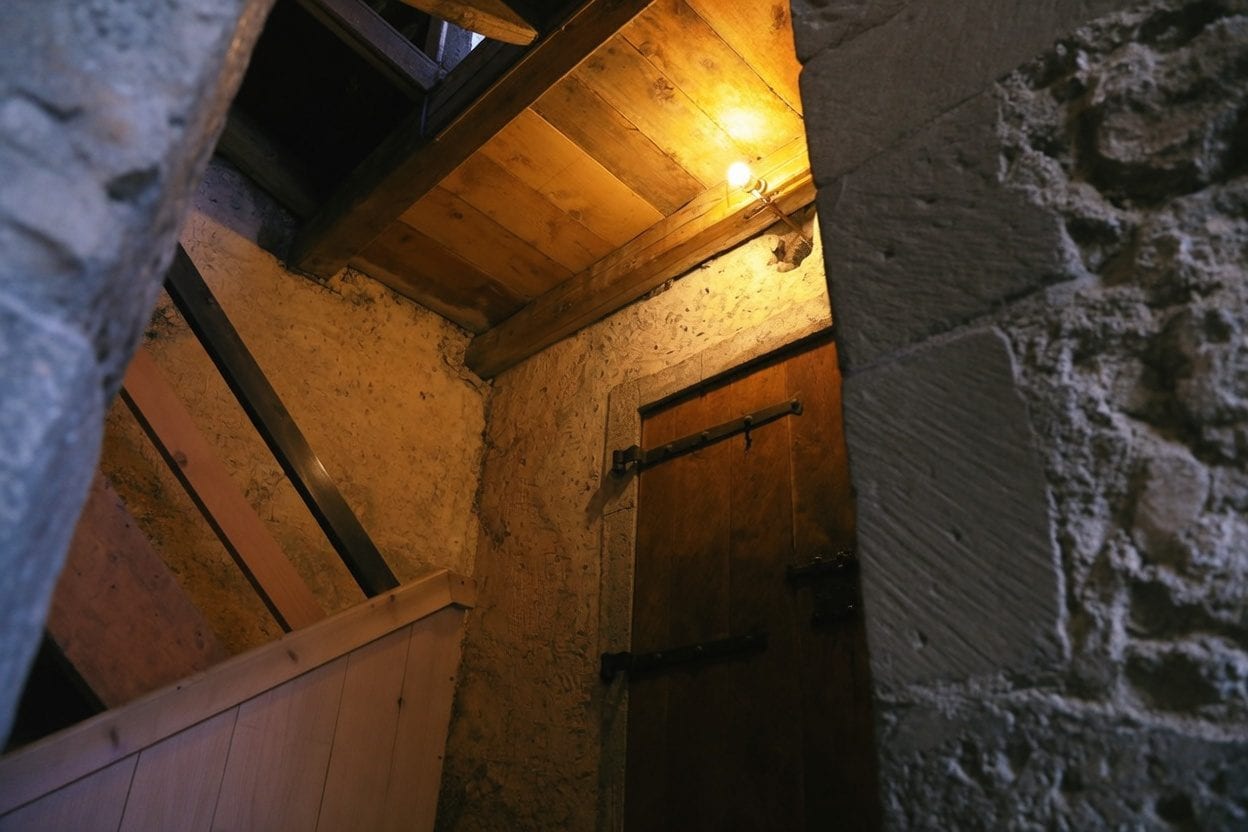 Escape room with mysterious dark atmosphere, locked door and dramatic lighting