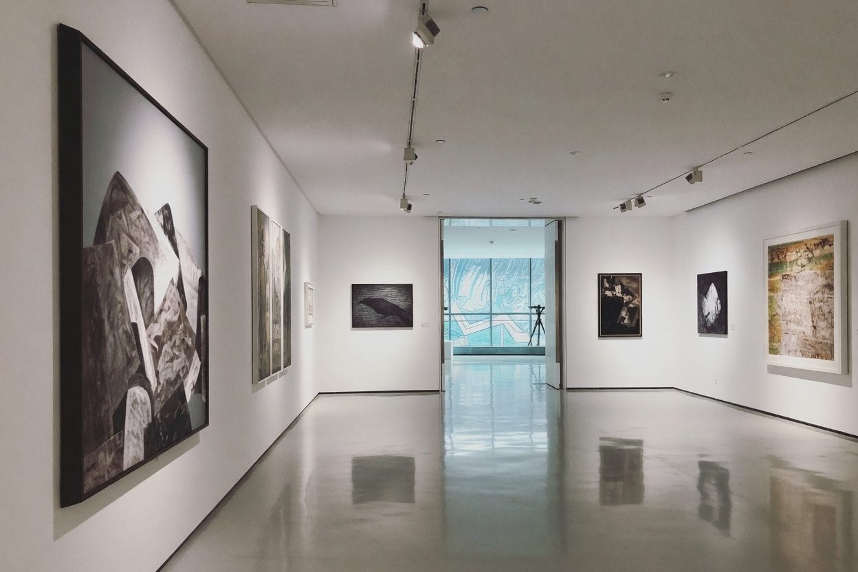 Museum gallery with visitors viewing art