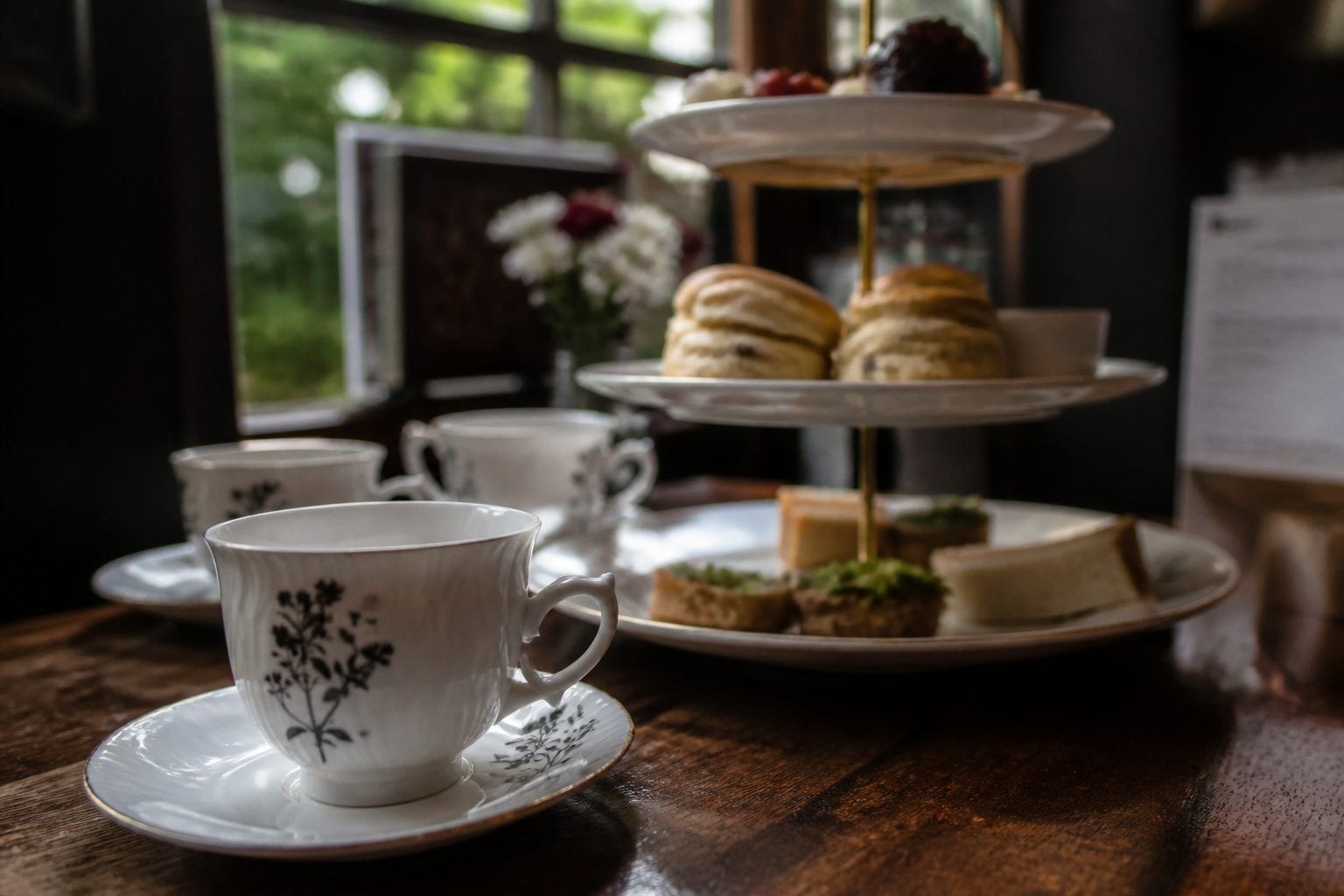 Elegant table setting with fine china and three-tiered stand