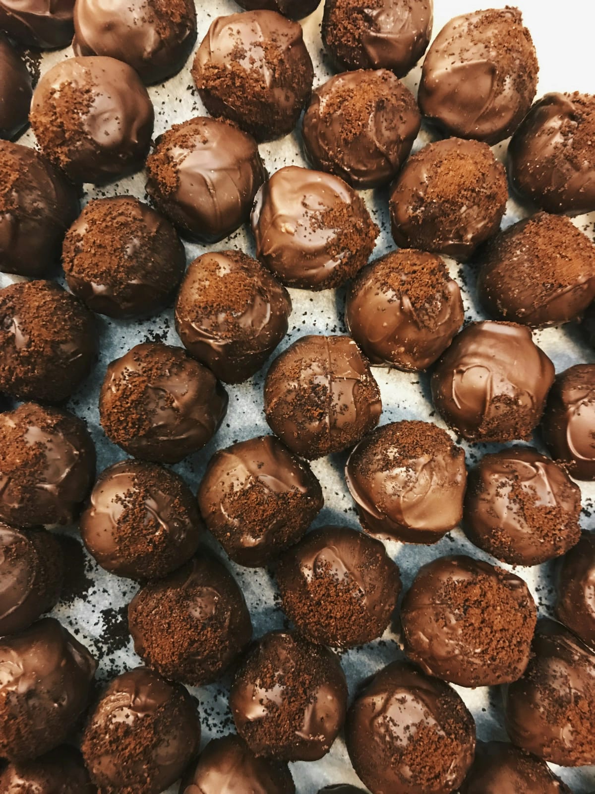 Artisan chocolate truffles and confections on display.