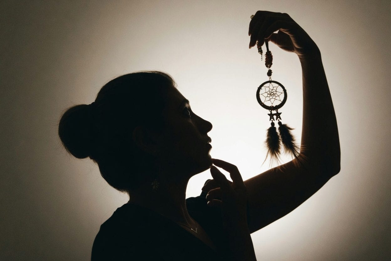 A silhouette of a person with a magnifying glass — capturing the investigative spirit of Crossroads