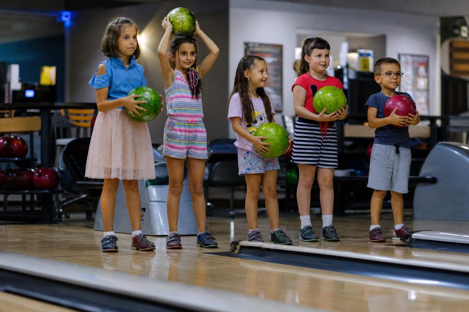 Kids bowling with bumpers and colourful lights