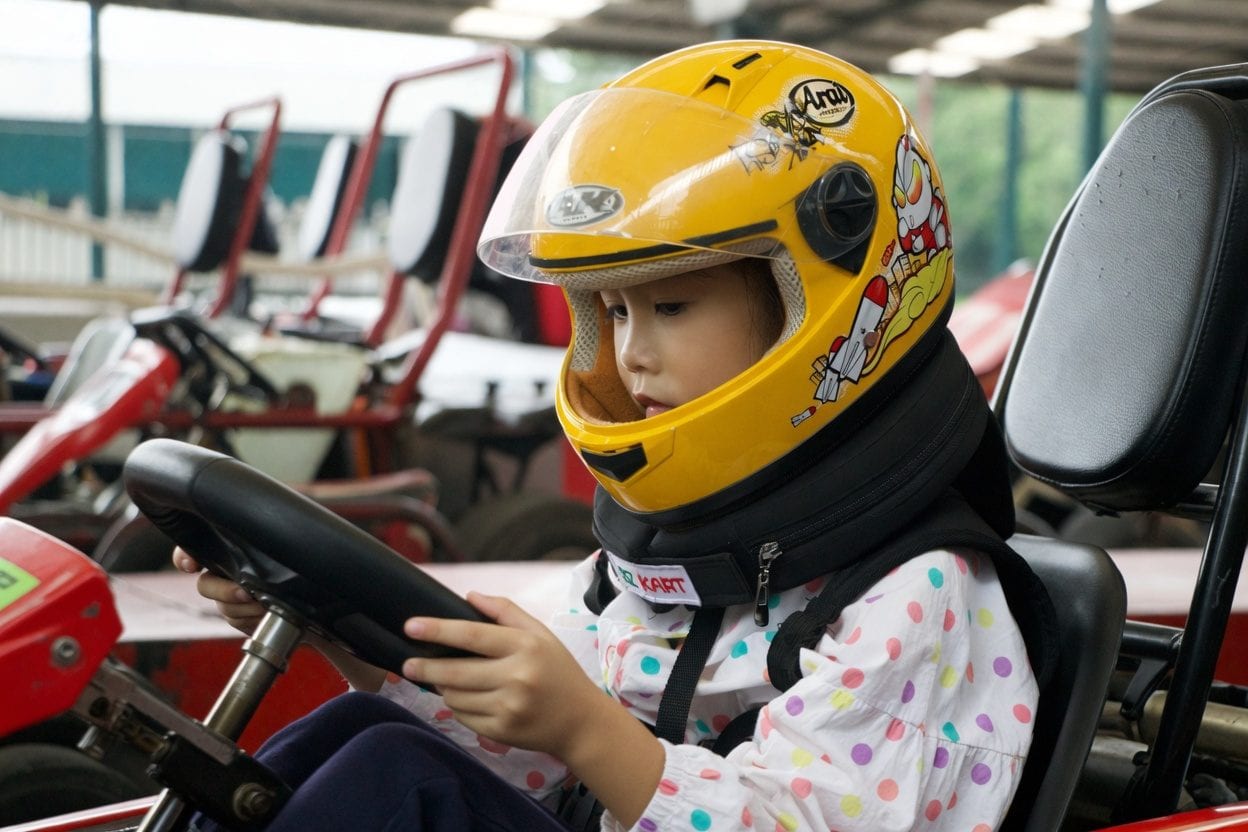 Kids racing go karts on a track
