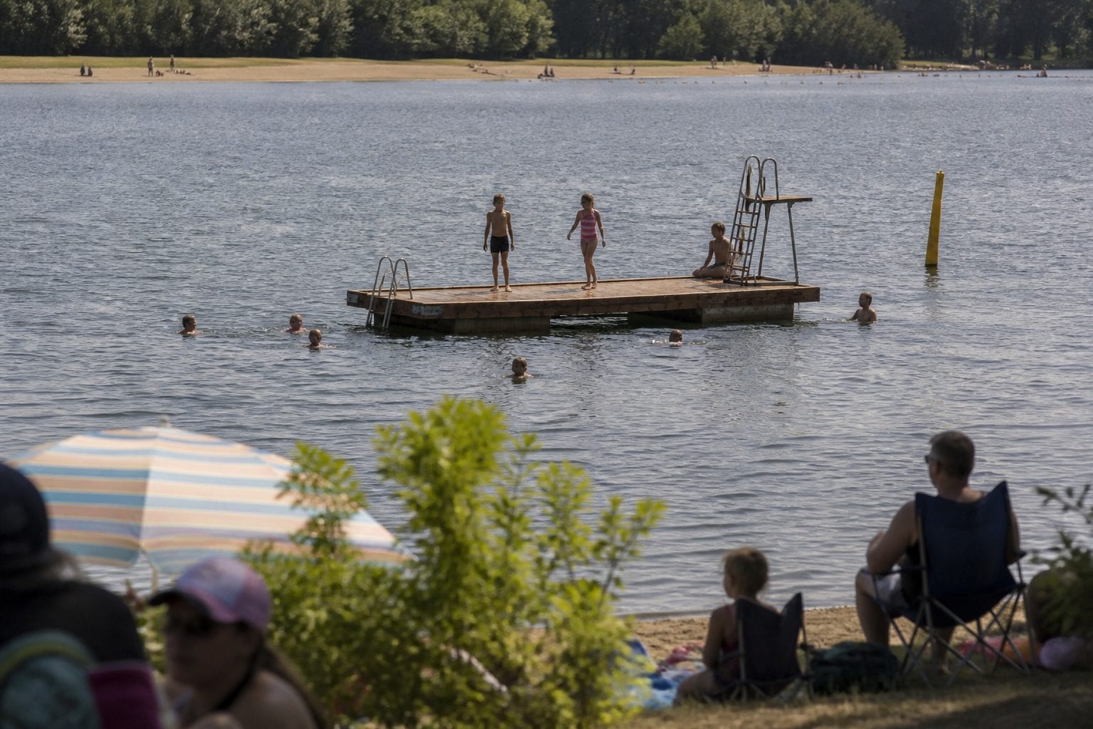 Petrie Island beach with families enjoying summer activities