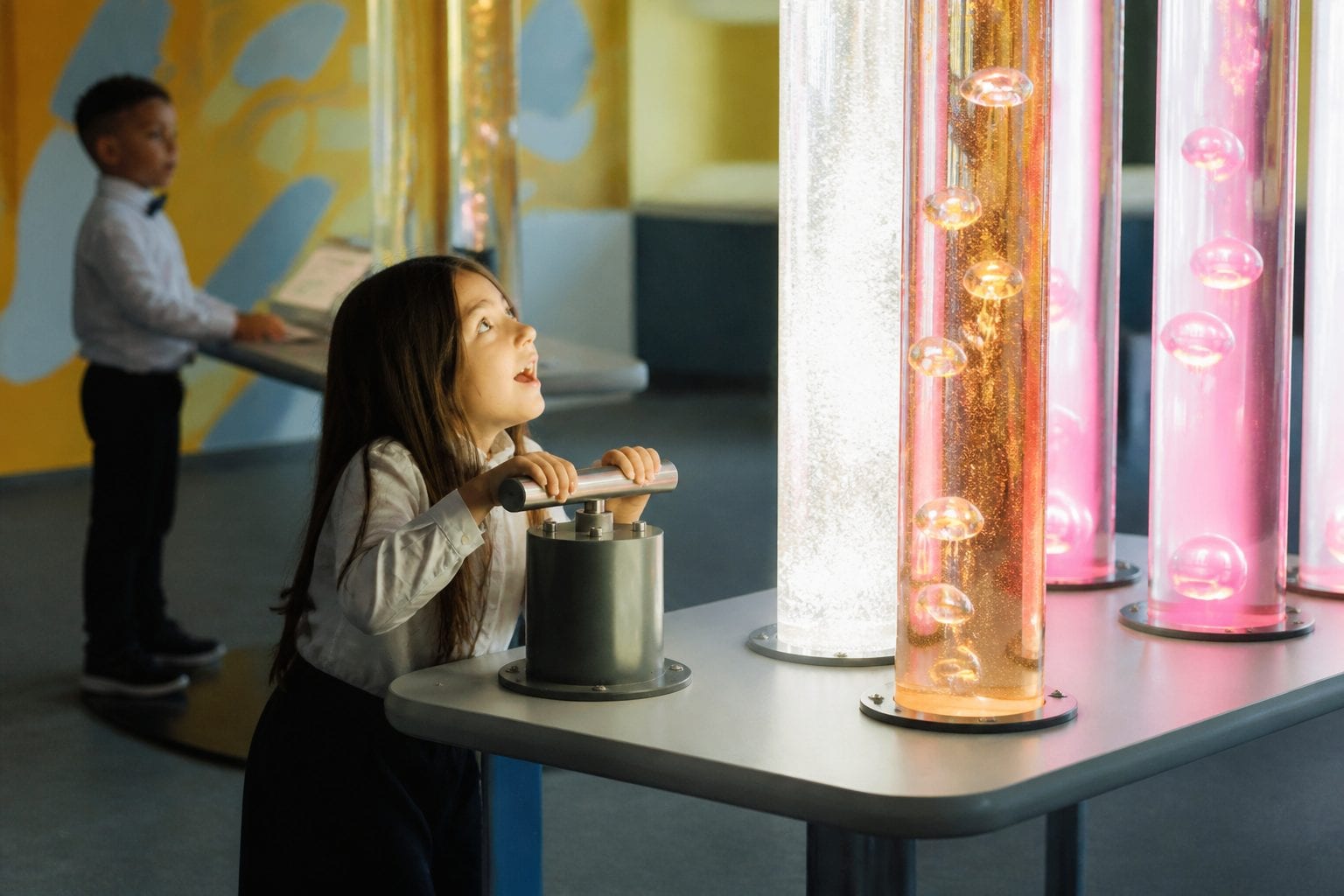 Families at a museum hands-on exhibit during March Break