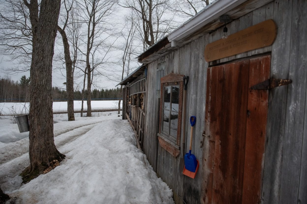 Maple sugar shack table and outdoor sap season scene near Ottawa