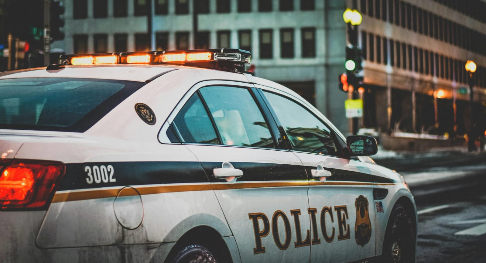 Police car with emergency lights at night scene.