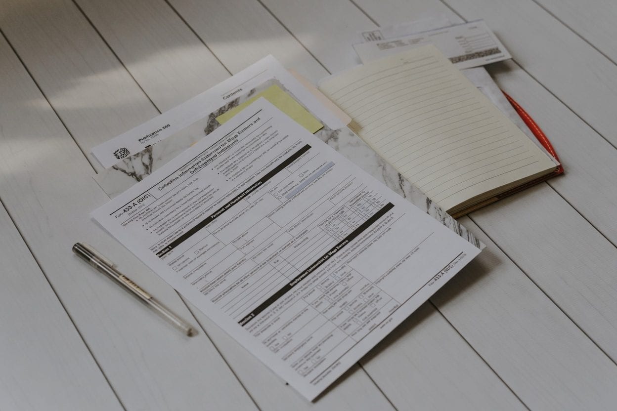 Tax forms and calculator representing financial planning