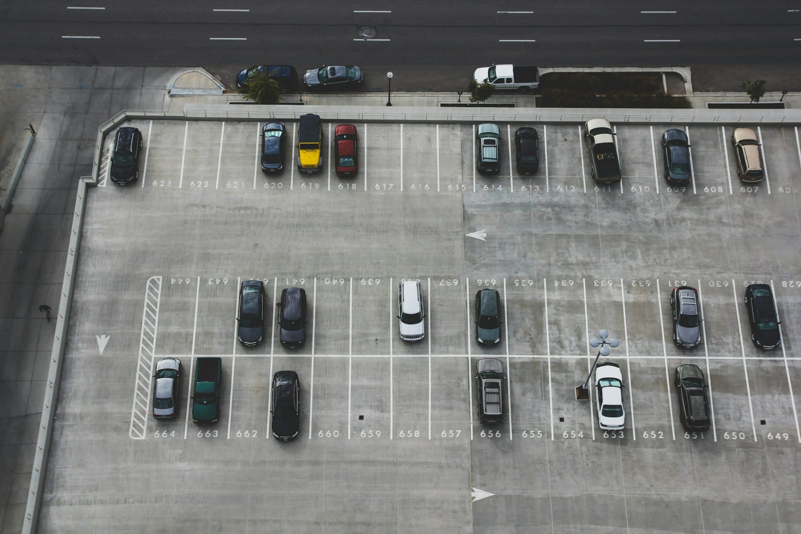 Parking meter and city street showing paid parking zones.