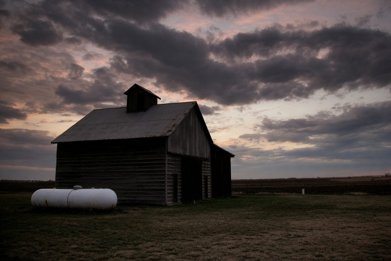 Family leaving a farm at sunset