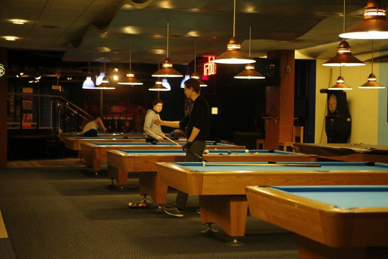 Snooker and pool tables inside a downtown Ottawa billiards bar