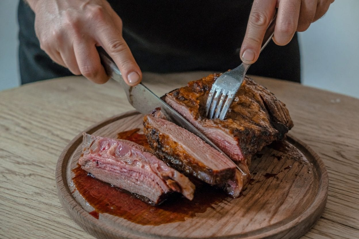 Plate of ribs with coleslaw and corn