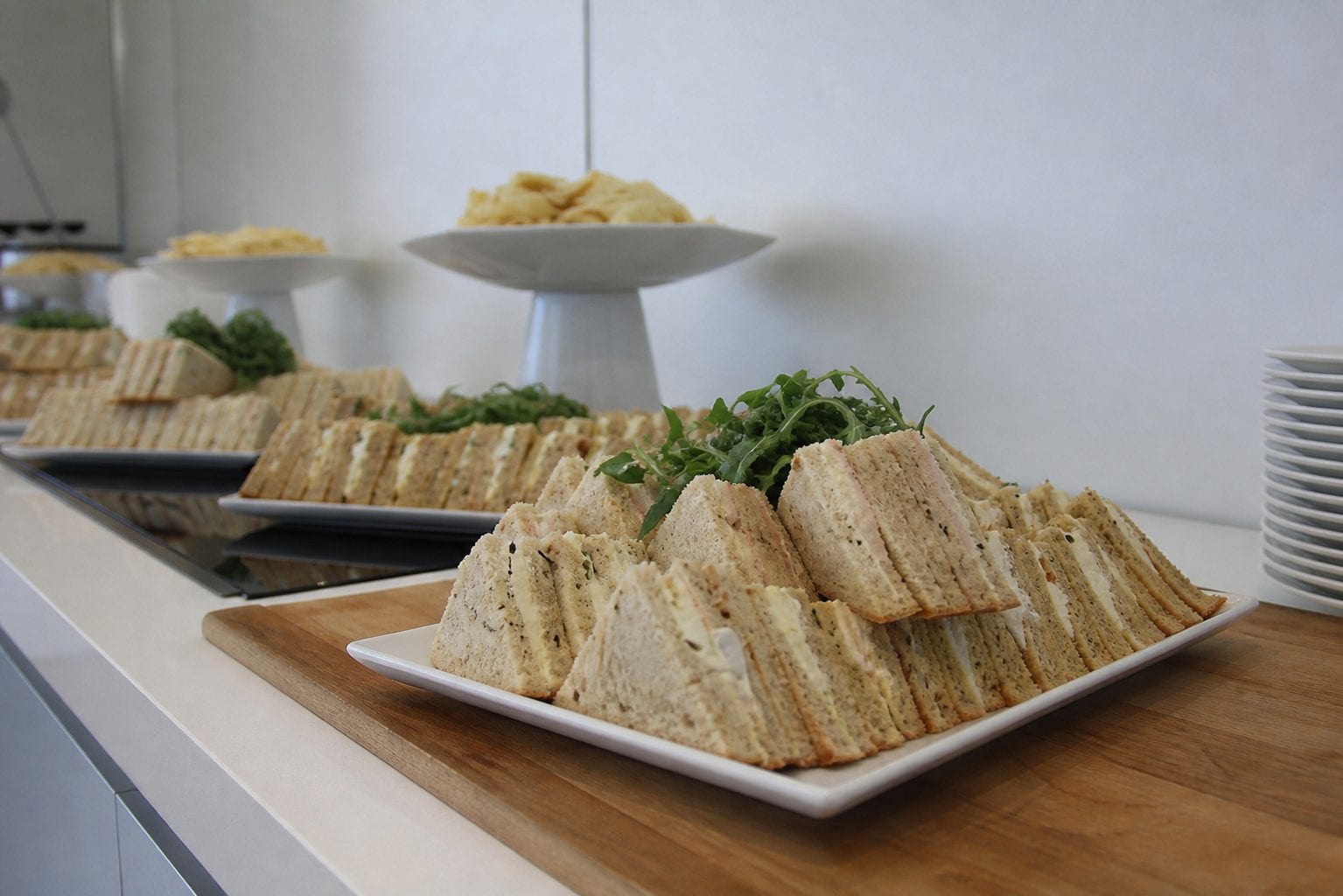 Stacked sandwiches on a wooden board