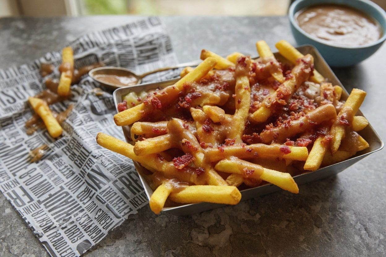 Loaded poutine with cheese curds, bacon, and rich gravy over crispy fries