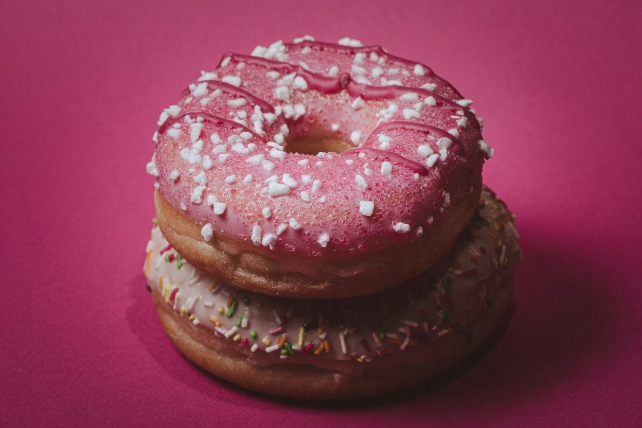 Colorful glazed donuts with sprinkles
