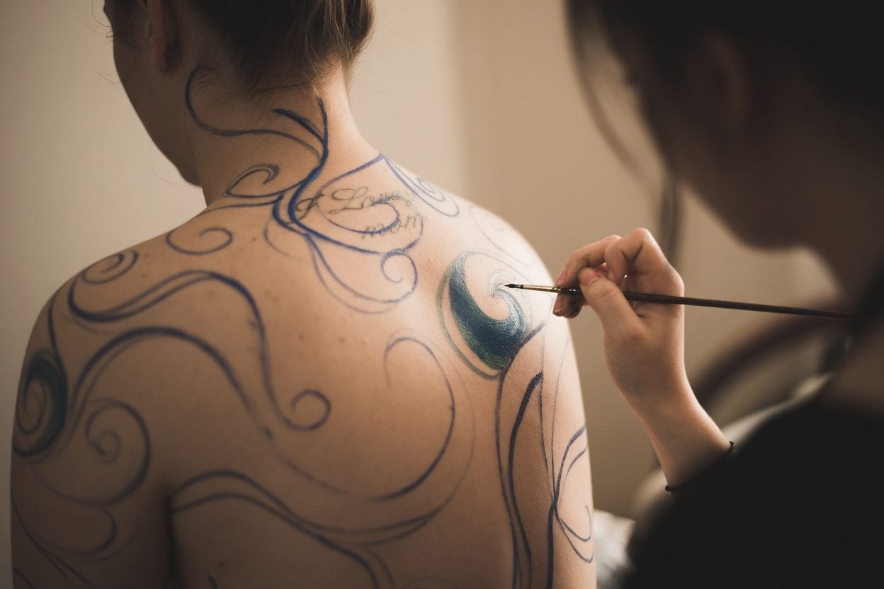 Tattoo artist with client consultation