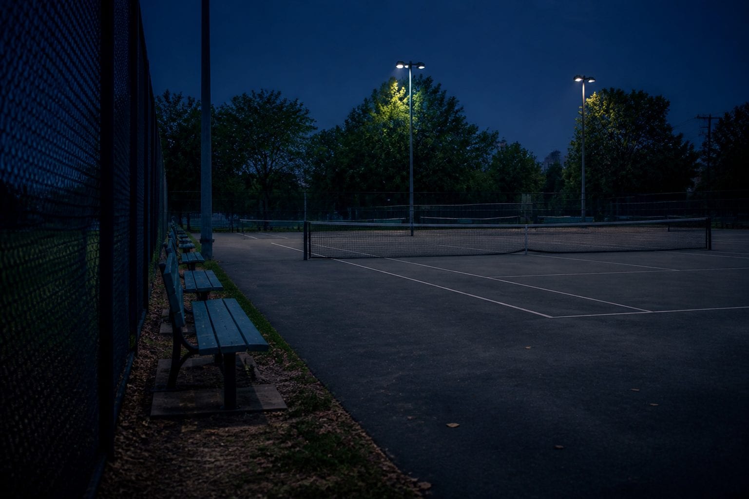 Lighted tennis courts in Ottawa at dusk
