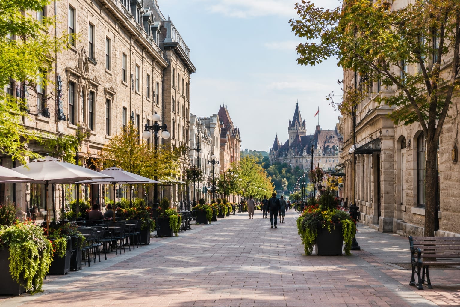 Pedestrians on a car-free downtown street lined with heritage stone buildings