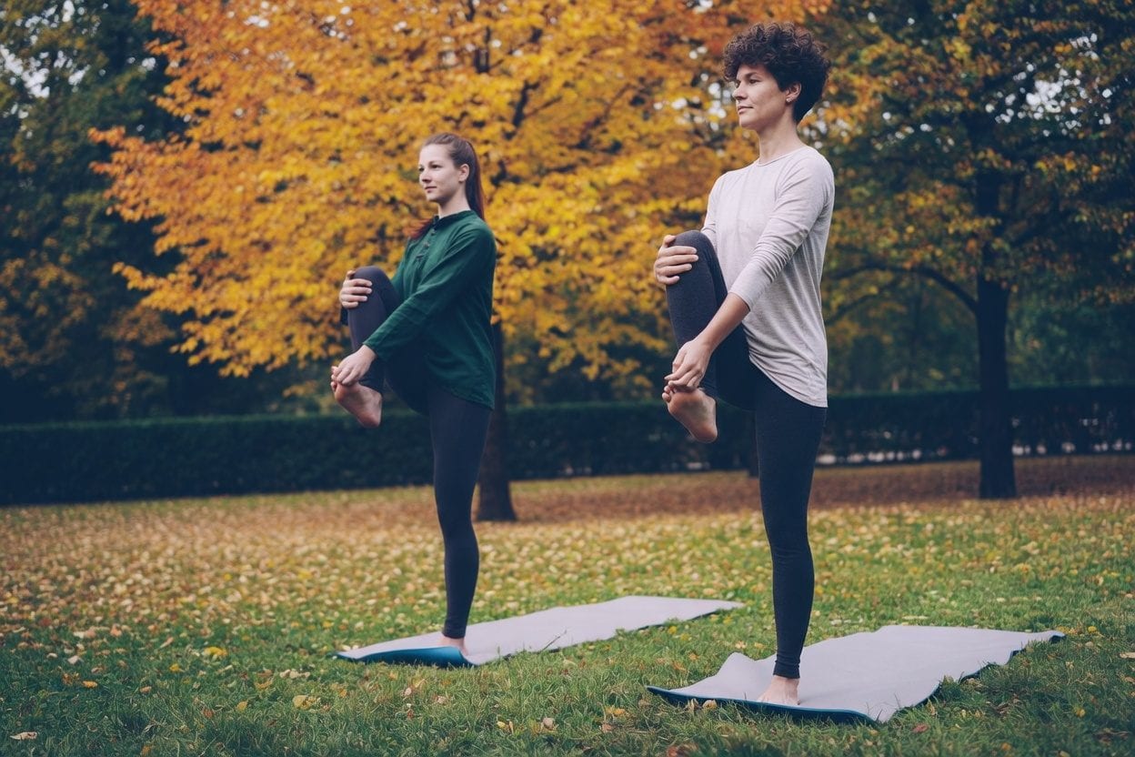 Outdoor yoga session in a city park